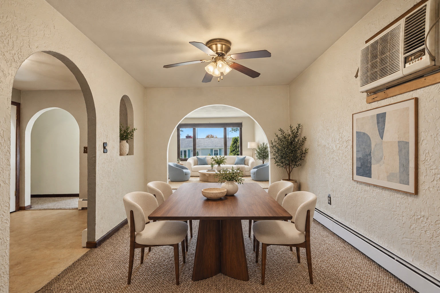 Virtually staged dining room with arched doorways